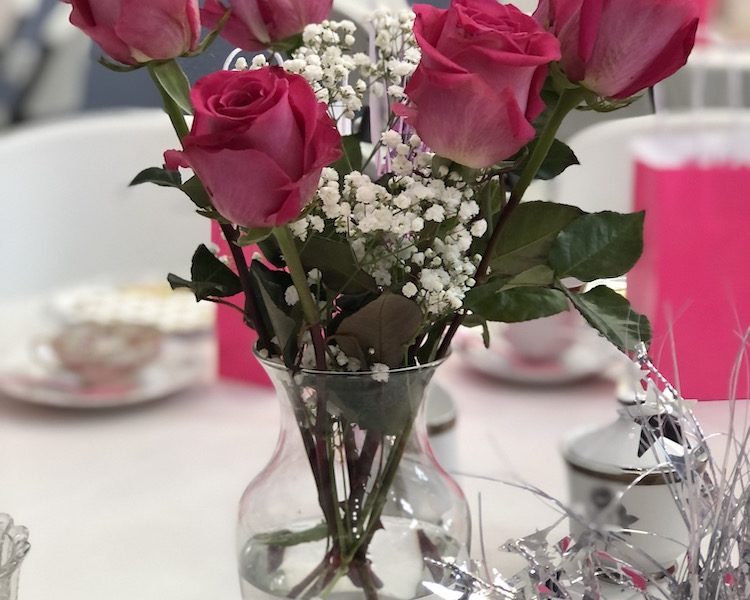 Pink rose centerpiece for women's health tea focused on breast cancer awareness