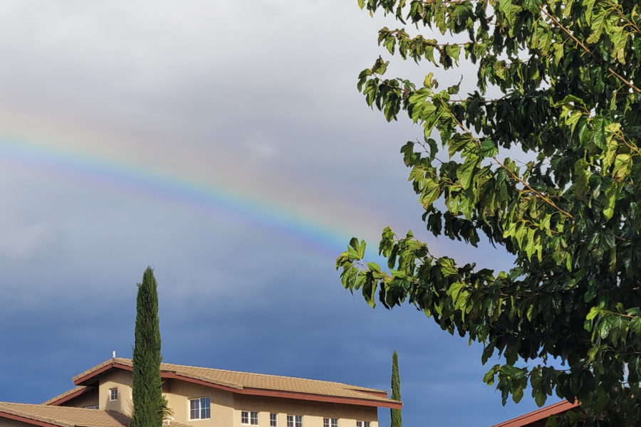 A Rainbow arcs across the sky over the 50-acre ranch campus of Rainbow Acres. a residential group home for adults with developmental disabilities.